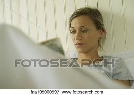 Woman reading in bed View Large Photo Image Stock Photo - Woman reading in bed. Fotosearch