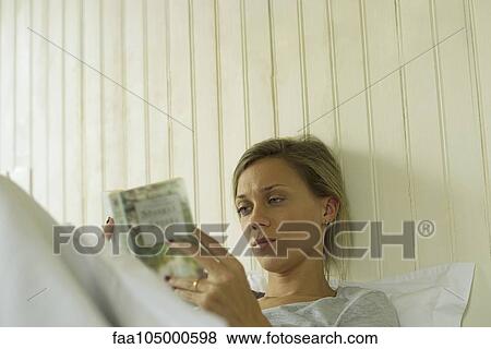 Woman reading in bed View Large Photo Image Stock Photo - Woman reading in bed. Fotosearch