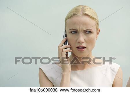 Woman receiving bad news on cell phone View Large Photo Image Stock Photo - Woman receiving bad news on cell phone. Fotosearch