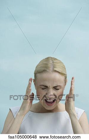 Stock Photo - Woman shouting with eyes closed. Fotosearch