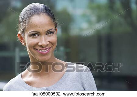 Stock Image - Woman smiling cheerfully, cropped. Fotosearch
