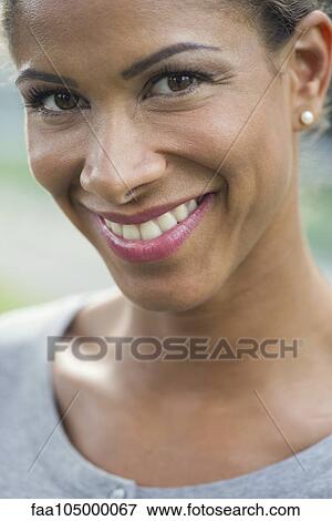 Stock Photo - Woman smiling cheerfully, portrait. Fotosearch