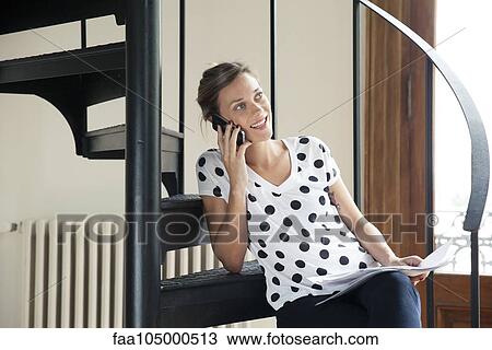 Stock Image - Woman taking phone call on cell phone. Fotosearch