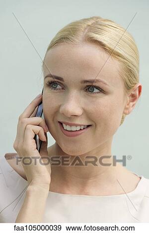 Woman talkiing on cell phone, smiling View Large Photo Image Stock Photo - Woman talkiing on cell phone, smiling. Fotosearch