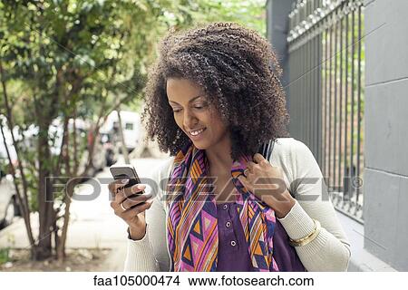 Woman using cell phone View Large Photo Image Picture - Woman using cell phone. Fotosearch