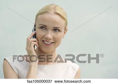 Woman using cell phone, smiling View Large Photo Image Stock Photo - Woman using cell phone, smiling. Fotosearch