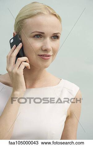 Woman using cell phone View Large Photo Image Stock Image - Woman using cell phone. Fotosearch