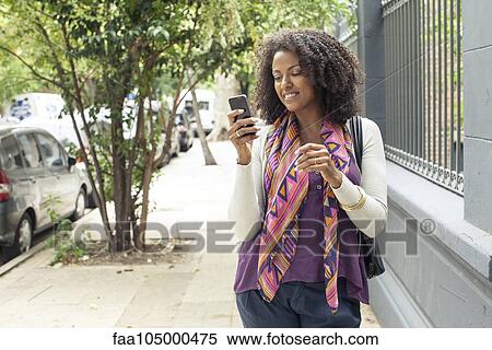 Woman using cell phone View Large Photo Image Stock Photography - Woman using cell phone. Fotosearch