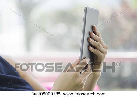 Woman using digital tablet, cropped View Large Photo Image Stock Photography - Woman using digital tablet, cropped. Fotosearch