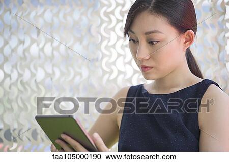 Woman using digital tablet View Large Photo Image Stock Image - Woman using digital tablet. Fotosearch