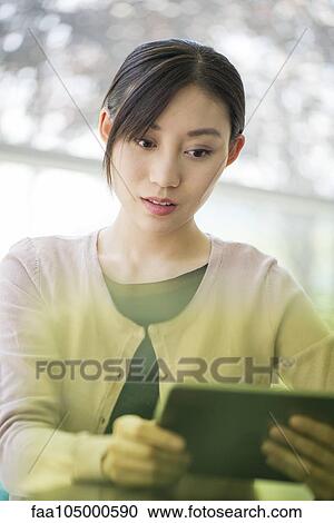 Stock Image - Woman using digital tablet. Fotosearch