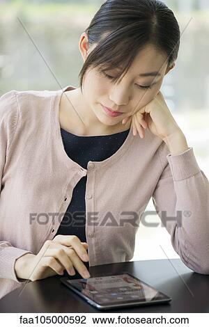Woman using digital tablet View Large Photo Image Stock Image - Woman using digital tablet. Fotosearch