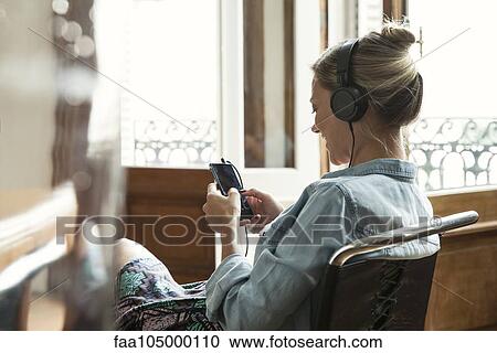Woman using multimedia smartphone View Large Photo Image Stock Image - Woman using multimedia smartphone. Fotosearch