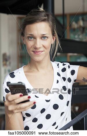Stock Image - Woman using smartphone. Fotosearch