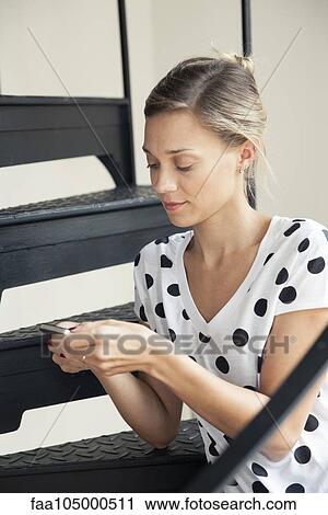 Stock Image - Woman using smartphone. Fotosearch