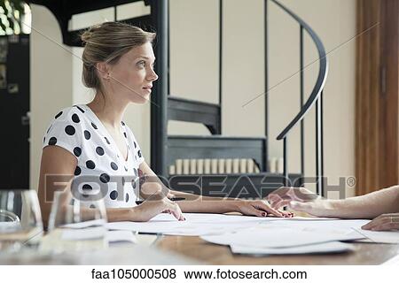 Stock Photo - Woman working with colleague. Fotosearch