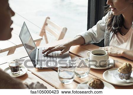 Women using laptop computer in coffee shop View Large Photo Image Stock Image - Women using laptop computer in coffee shop. Fotosearch