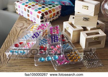 Wooden jewelry boxes and stick-on jewels at birthday party View Large Photo Image Stock Photo - Wooden jewelry boxes and stick-on jewels at birthday party. Fotosearch