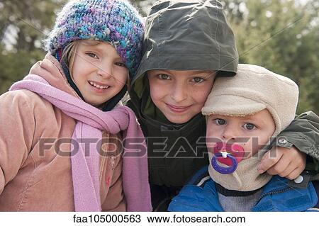 Young siblings dressed in winter clothing, portrait View Large Photo Image Stock Image - Young siblings dressed in winter clothing, portrait. Fotosearch