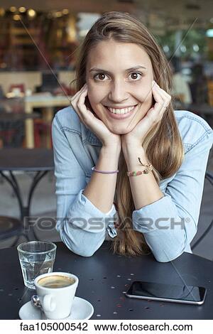 Young woman relaxing at cafe, portrait View Large Photo Image Stock Image - Young woman relaxing at cafe, portrait. Fotosearch