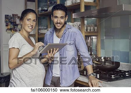 Accessing recipes on digital tablet makes cooking healthy easier than ever View Large Photo Image Stock Image - Accessing recipes on digital tablet makes cooking healthy easier than ever. Fotosearch
