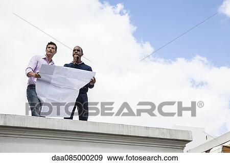 Architects contemplating development plan View Large Photo Image Stock Photo - Architects contemplating development plan. Fotosearch