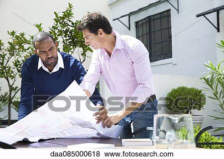 Architects discussing blueprint View Large Photo Image Stock Photo - Architects discussing blueprint. Fotosearch