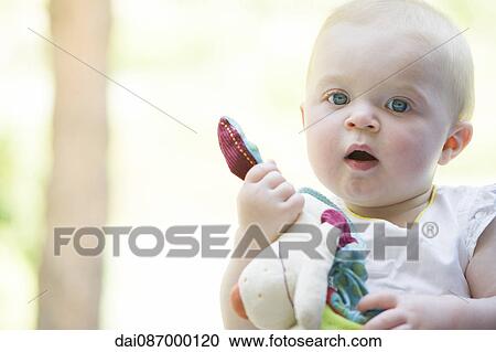 Baby holding stuffed toy, portrait View Large Photo Image Stock Image - Baby holding stuffed toy, portrait. Fotosearch