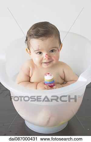 Baby sitting in bath with tube of colorful soap View Large Photo Image Stock Image - Baby sitting in bath with tube of colorful soap. Fotosearch