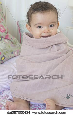 Baby wrapped in a towel after a bath, portrait View Large Photo Image Picture - Baby wrapped in a towel after a bath, portrait. Fotosearch