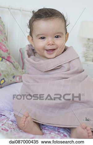 Baby wrapped in a towel, smiling, portrait View Large Photo Image Stock Photography - Baby wrapped in a towel, smiling, portrait. Fotosearch