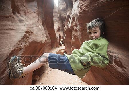Boy balancing in narrow slot canyon View Large Photo Image Picture - Boy balancing in narrow slot canyon. Fotosearch