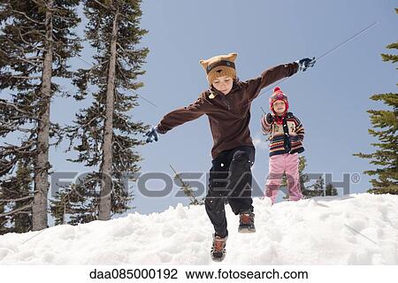 Boy jumping in snow View Large Photo Image Stock Image - Boy jumping in snow. Fotosearch