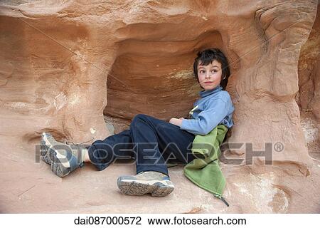 Boy relaxing on rock formation at Capitol Reef National Park, Utah, USA View Large Photo Image Stock Image - Boy relaxing on rock formation at Capitol Reef National Park, Utah, USA. Fotosearch