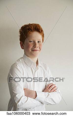 Boy smiling confidently with arms folded, portrait View Large Photo Image Stock Image - Boy smiling confidently with arms folded, portrait. Fotosearch