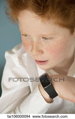 Boy speaking into smartwatch View Large Photo Image Picture - Boy speaking into smartwatch. Fotosearch