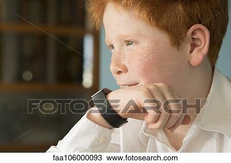 Boy speaking into smartwatch View Large Photo Image Stock Image - Boy speaking into smartwatch. Fotosearch