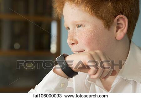 Boy speaking into smartwatch View Large Photo Image Stock Image - Boy speaking into smartwatch. Fotosearch