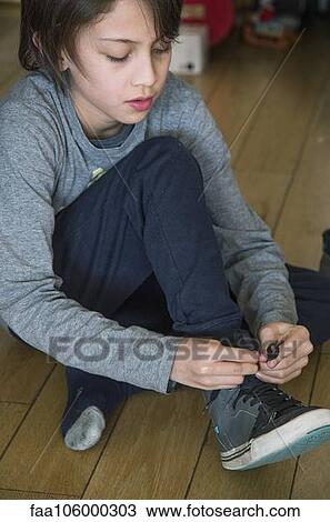 Boy tying his shoe View Large Photo Image Stock Image - Boy tying his shoe. Fotosearch