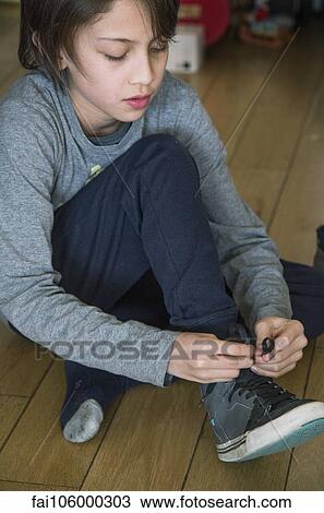 Boy tying his shoe View Large Photo Image Stock Image - Boy tying his shoe. Fotosearch