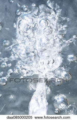 Stock Photography - Bubbles in frozen water. Fotosearch