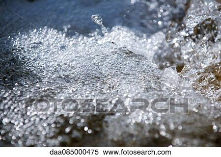 Bubbles on surface of flowing water View Large Photo Image Stock Photography - Bubbles on surface of flowing water. Fotosearch