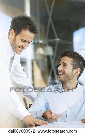 Stock Image - Business professionals collaborating. Fotosearch