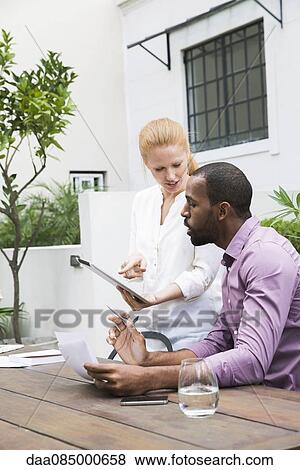 Stock Photo - Business professionals using digital tablet. Fotosearch