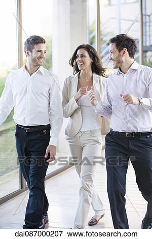 Stock Photo - Business team members chatting with enthusiasm. Fotosearch