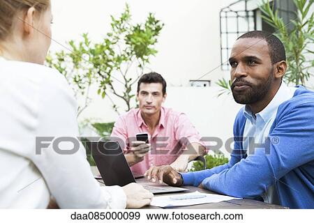 Business team members together at project meeting View Large Photo Image Stock Photo - Business team members together at project meeting. Fotosearch