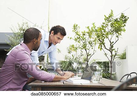 Stock Photo - Businessman asking for colleagues feedback. Fotosearch