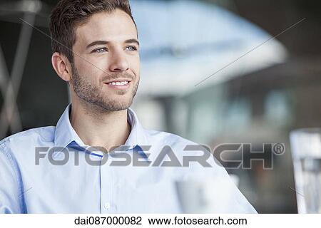 Stock Image - Businessman contemplating, portrait. Fotosearch