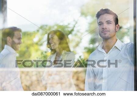 Businessman looking out window lost in thought View Large Photo Image Stock Image - Businessman looking out window lost in thought. Fotosearch
