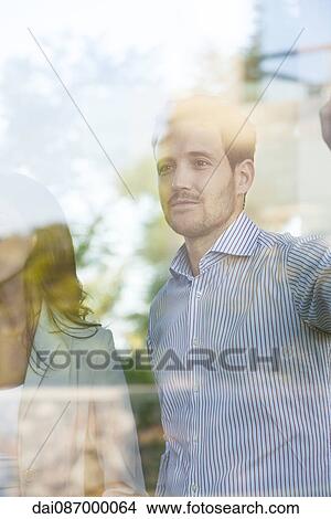 Businessman lost in thought gazing out window View Large Photo Image Picture - Businessman lost in thought gazing out window. Fotosearch